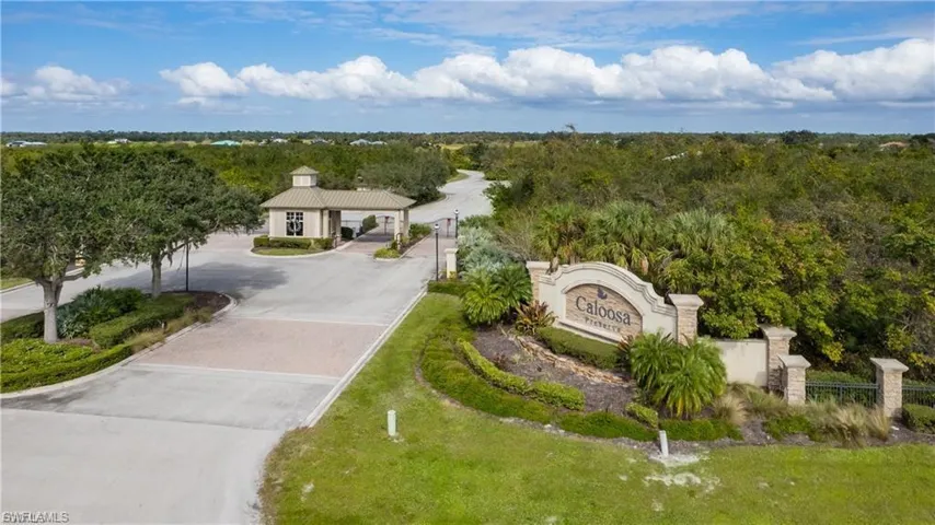 Aerial view of property and surrounding area with a heavily wooded area