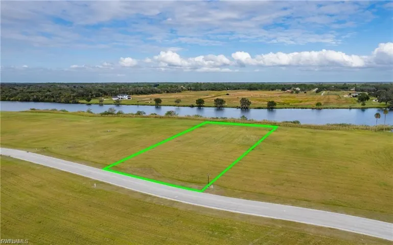 Overview of rural landscape with a large body of water and property boundaries highlighted