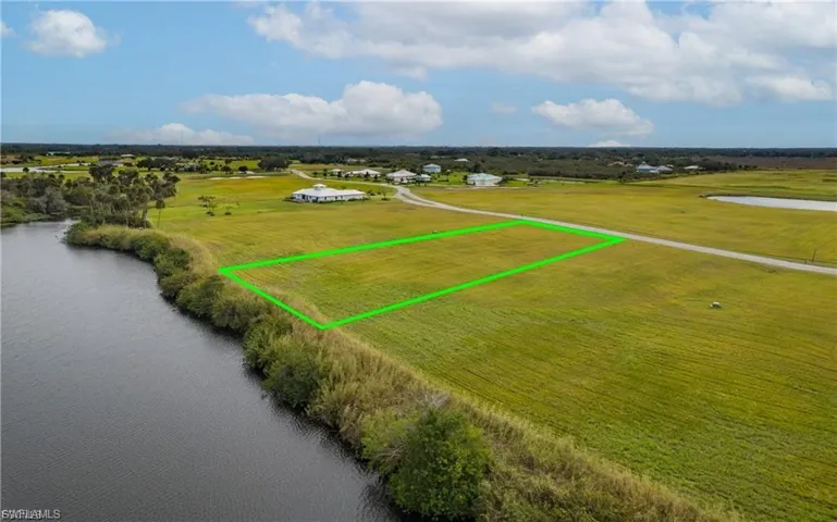 View of rural area with a large body of water and property boundaries highlighted