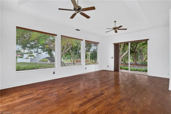 Spacious interior featuring wood flooring and a tray ceiling