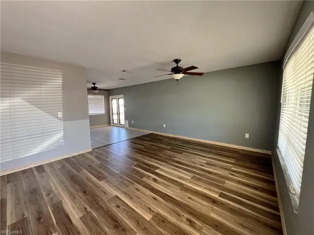 Empty room with wood finished floors and ceiling fan