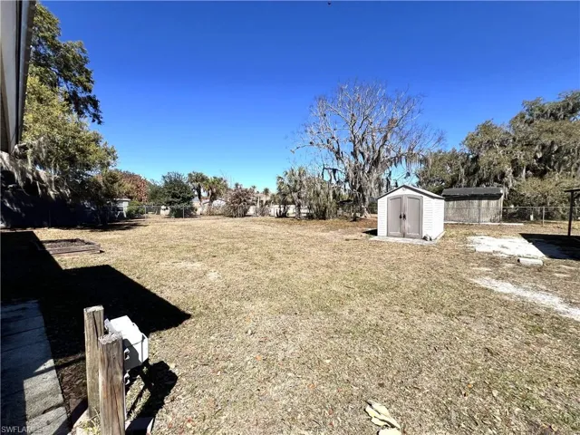 Fenced backyard with a storage shed