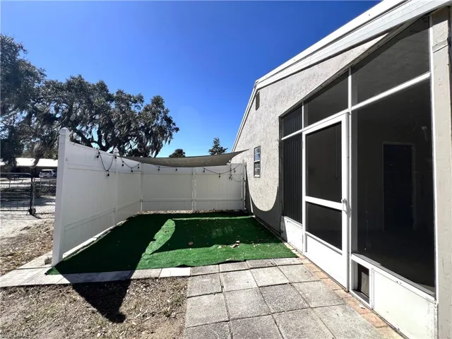 Fenced backyard with a sunroom