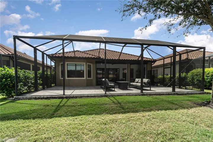 Rear view of property showcases the large screened in lanai