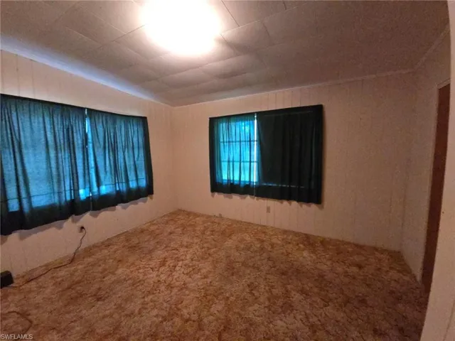 Empty room with carpet flooring