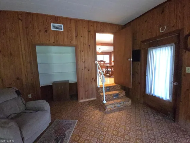 Entrance foyer with a healthy amount of sunlight and wooden walls