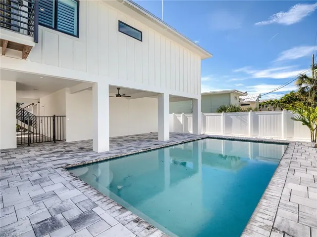 View of pool with a patio and ceiling fan