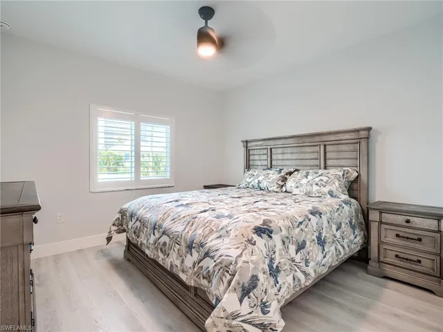 Bedroom with ceiling fan and light hardwood / wood-style floors