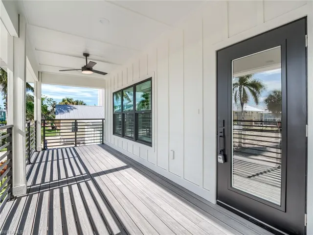 Wooden terrace featuring ceiling fan