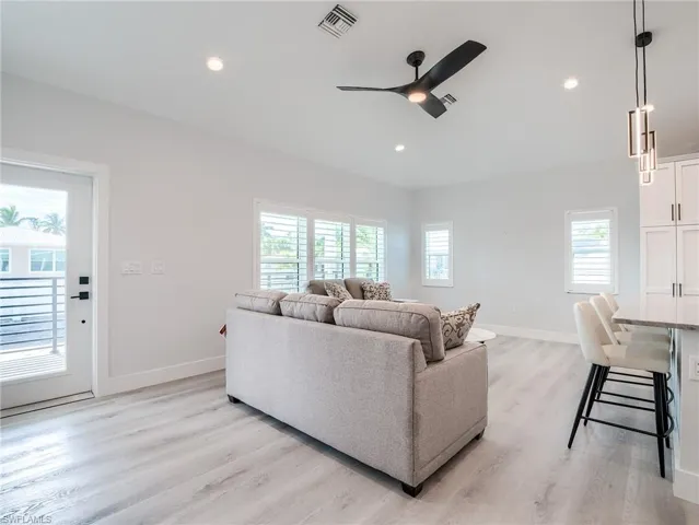 Living room featuring light hardwood / wood-style floors and ceiling fan