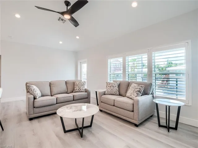 Living room featuring ceiling fan and light hardwood / wood-style flooring