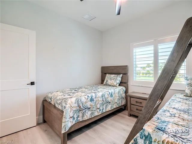 Bedroom with ceiling fan and light wood-type flooring