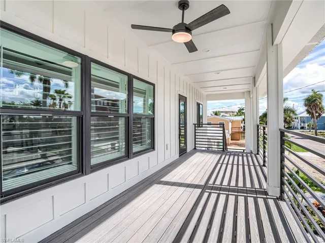 Wooden terrace featuring ceiling fan