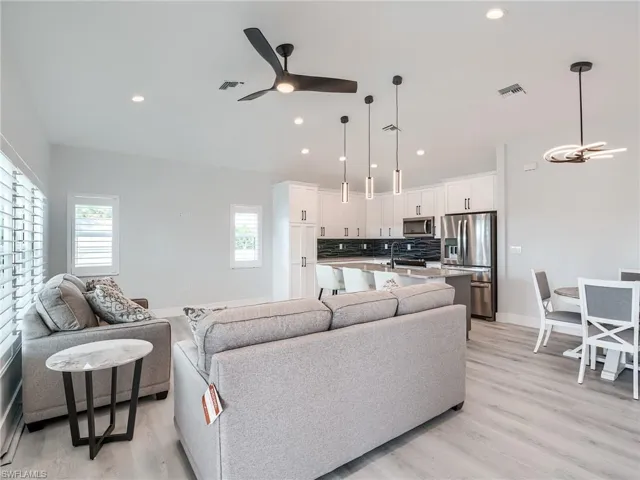 Living room featuring light hardwood / wood-style floors, sink, and ceiling fan