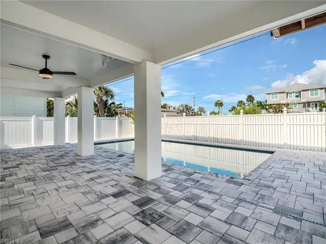 View of pool featuring a patio area and ceiling fan