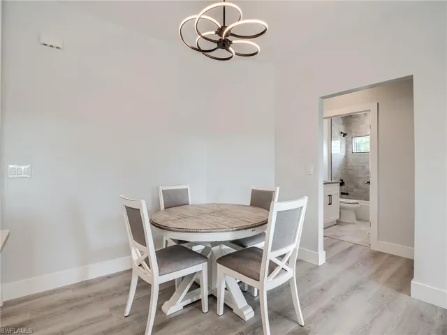 Dining room featuring light hardwood / wood-style floors and a notable chandelier