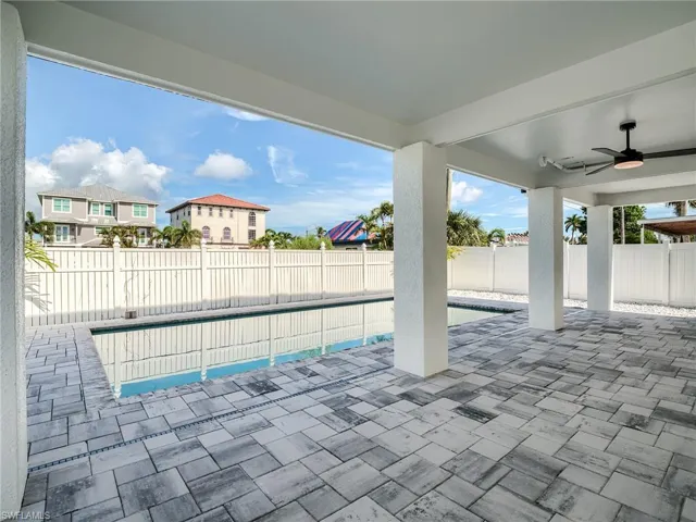 View of pool with a patio and ceiling fan