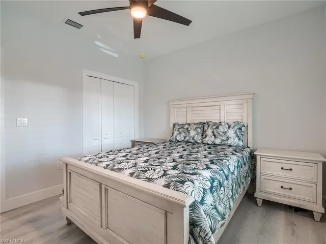 Bedroom featuring a closet, ceiling fan, and light hardwood / wood-style flooring