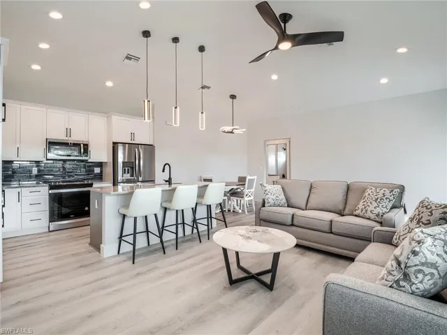 Living room featuring ceiling fan and light hardwood / wood-style floors