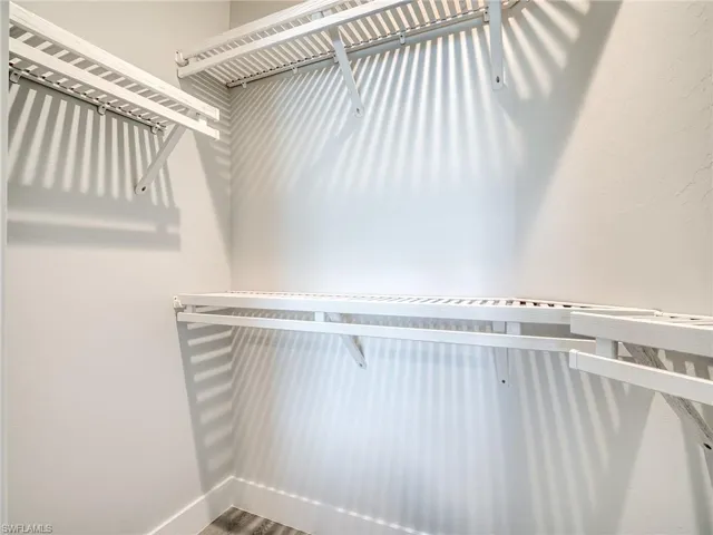 Spacious closet with hardwood / wood-style floors