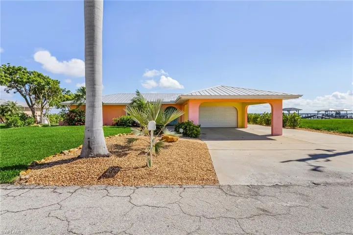 Street view of home, with plenty of concrete parking, large enough for a RV, boat and/or trailer.
