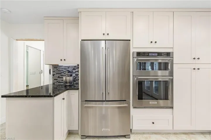 All new Kitchen-aid Appliances, including wall oven, microwave, wall pantry, and granite counter.