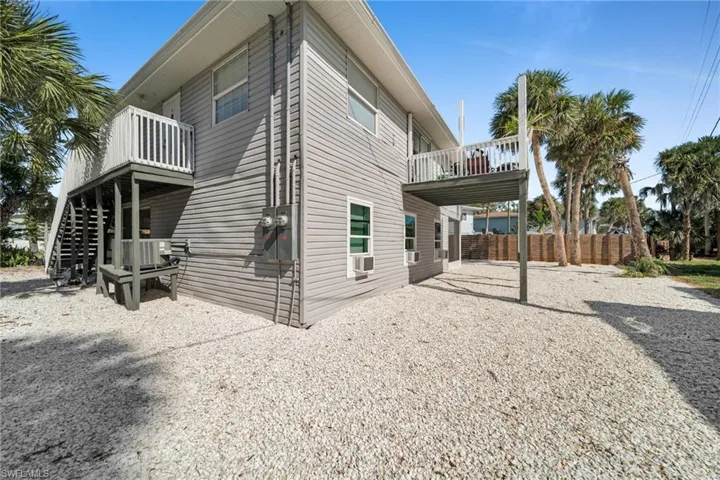 View of side of property with a patio area and a deck