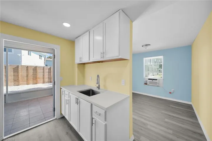 Kitchen with white cabinetry, light wood finished floors, and recessed lighting