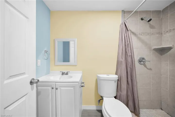 Full bathroom featuring vanity and a shower stall