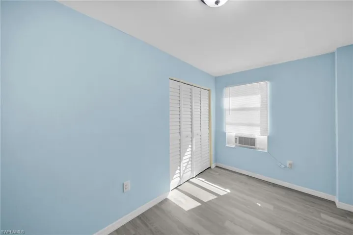 Unfurnished bedroom with light wood-type flooring and a closet