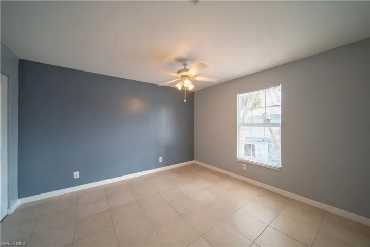 Spare room with baseboards and a ceiling fan