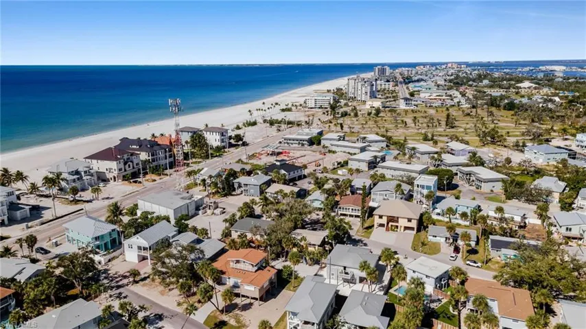Aerial perspective of suburban area featuring expansive coastline