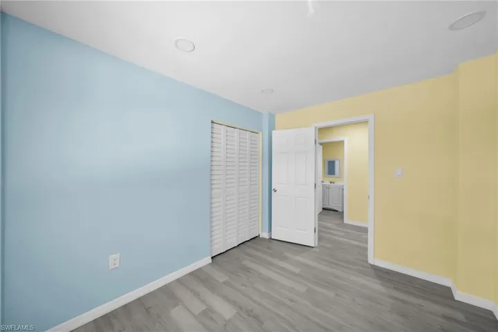 Unfurnished bedroom featuring light wood finished floors and a closet