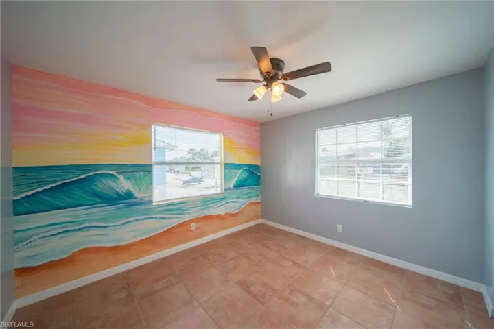 Spare room featuring an accent wall and ceiling fan
