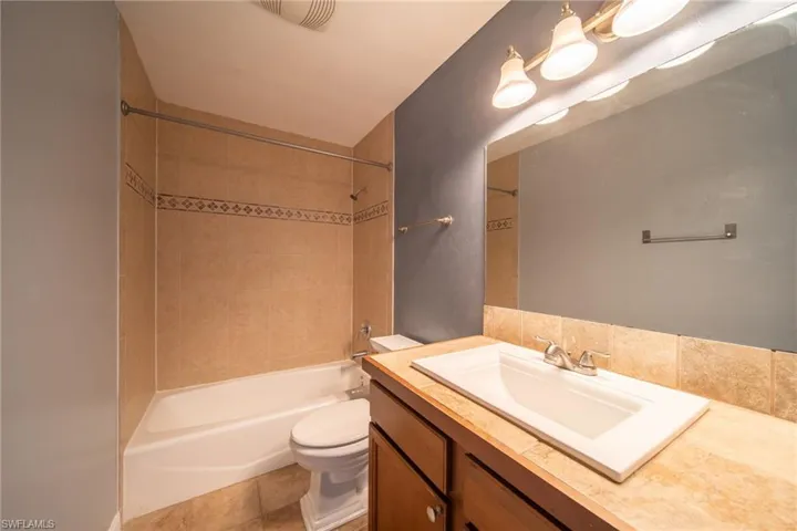 Bathroom featuring vanity and shower / tub combination