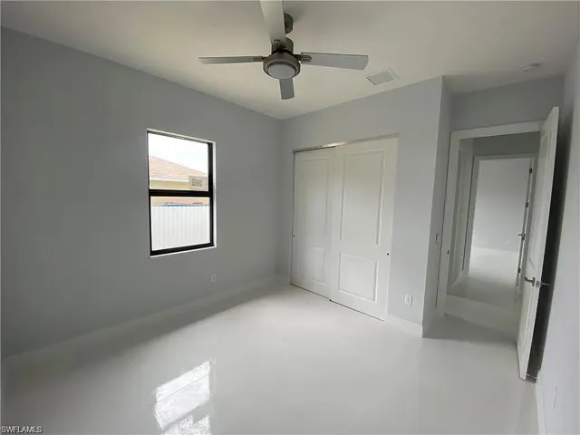 Unfurnished bedroom with a closet and a ceiling fan