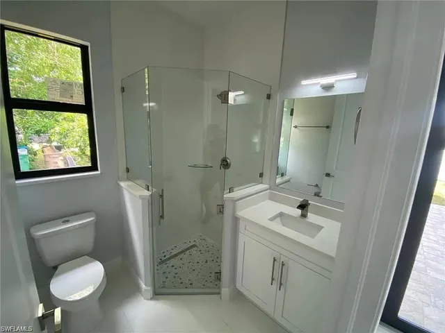 Bathroom featuring vanity and a shower stall