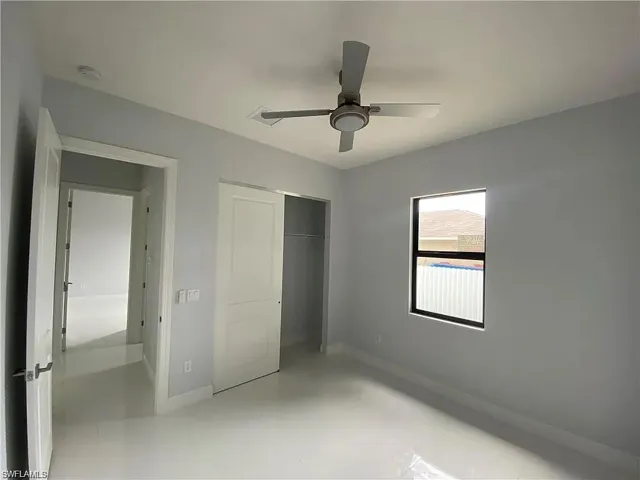 Unfurnished bedroom featuring a closet and a ceiling fan