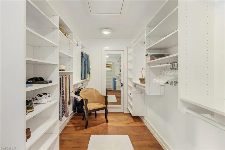 Walk in closet with light wood-style flooring