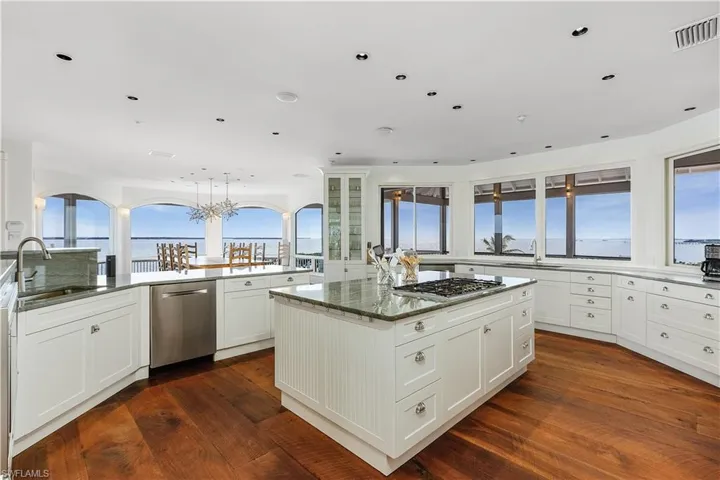 Kitchen with white cabinets, stainless appliances and panoramic water view