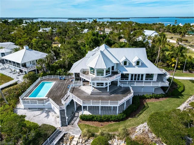 View from above of property with a pool and a large body of water