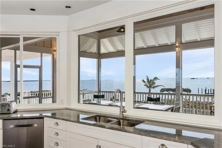 Kitchen featuring water views and outdoor dining beyond