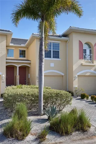 View of front of house featuring stucco siding and a garage