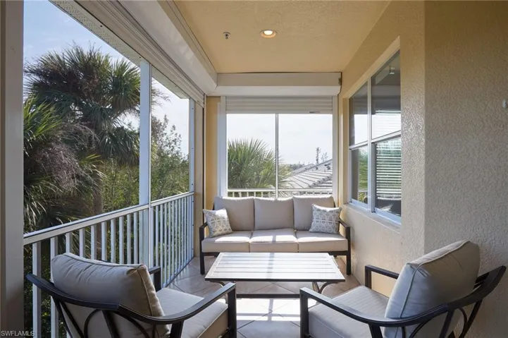 Sunroom with a textured wall and a textured ceiling