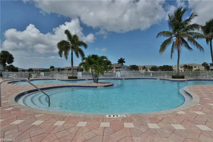 Community pool with a patio