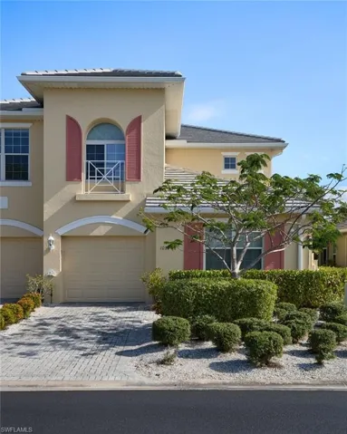 View of front of house featuring decorative driveway, stucco siding, and a garage