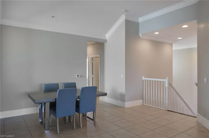 Dining space with recessed lighting, ornamental molding, and light tile patterned floors