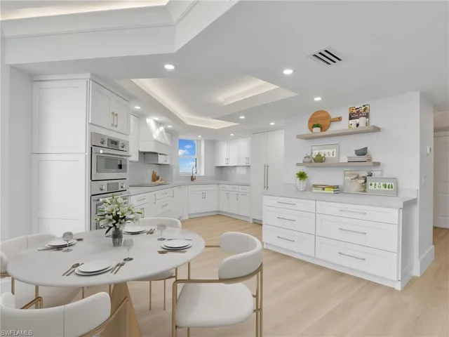 Kitchen with a sink, light wood-style flooring, white cabinetry, light countertops, and recessed lighting