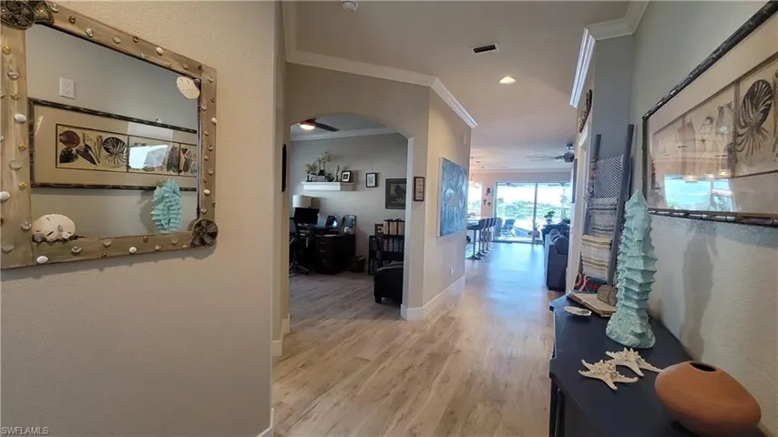 Hallway featuring ornamental molding and wood-type flooring