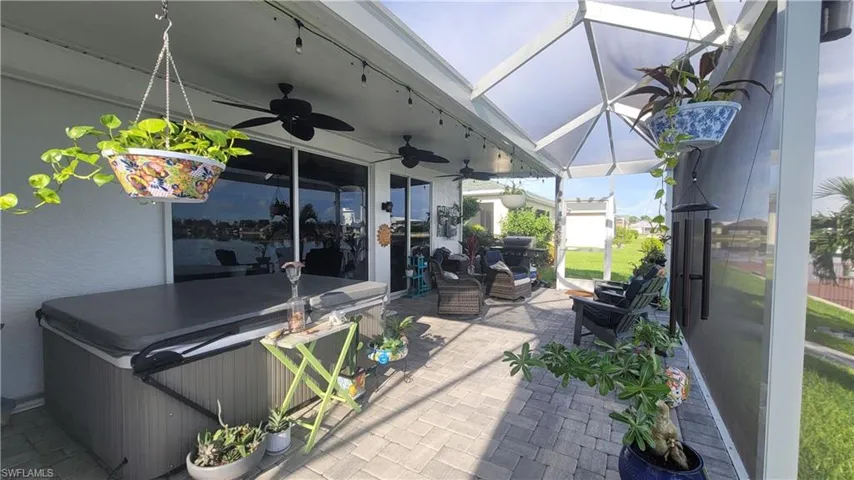 View of patio / terrace featuring an outdoor hangout area, a hot tub, and ceiling fan